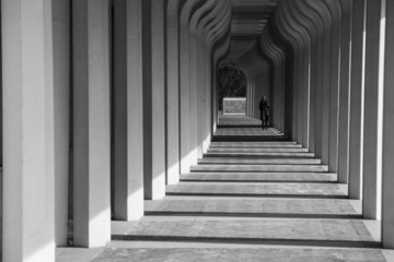 Ragazza che cammina in un corridoio porticato © nikhg