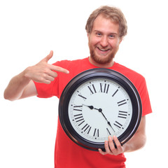 Bearded happy man holding big clock and smiling