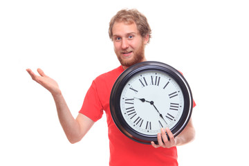 Bearded man holding big clock and pointing