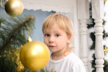 Fototapeta na wymiar blond boy in christmas interior