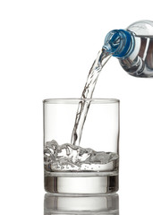 Cold water bottle pour water to glass on white