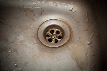 Old rusty drain hole in the sink