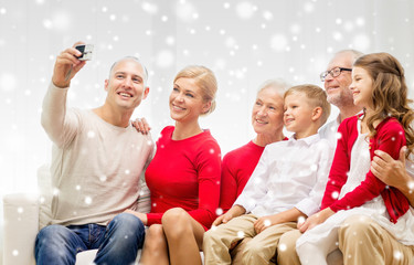 smiling family with camera at home