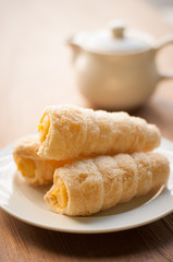 Cream-filled pastry roll on the wood board