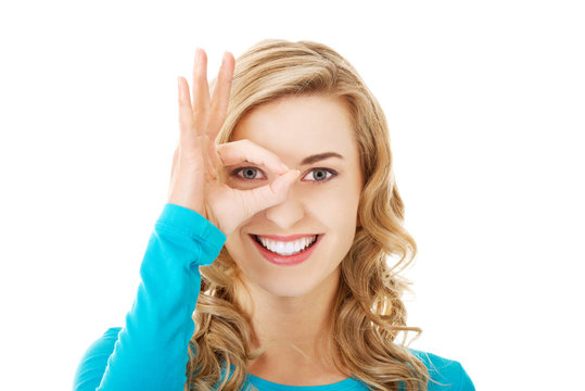 Portrait of a woman showing ok sign