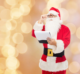 man in costume of santa claus with notepad