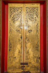 Traditional Thai door carving in temple