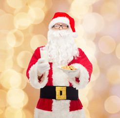 santa claus with glass of milk and cookies