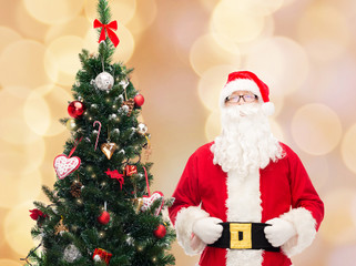 man in costume of santa claus with christmas tree