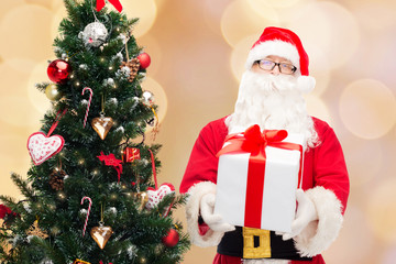 man in costume of santa claus with gift box