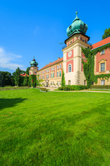 Fototapeta na wymiar Green gardens of Lancut castle on sunny summer day, Poland