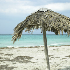 Fototapeta na wymiar Parasol on an abandonned beach