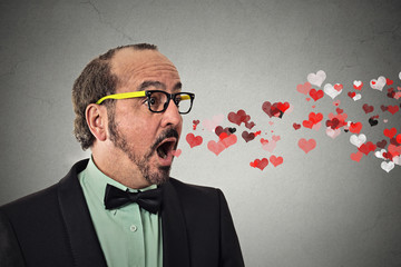 man sending kisses, red hearts coming flying out of open mouth