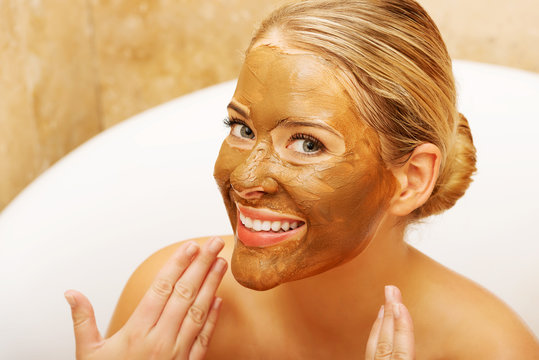 Woman showing her face with chocolate mask