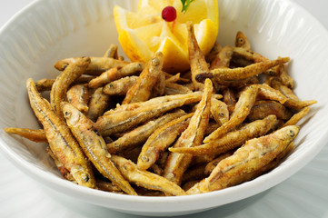 Smelt, capelin, small mackerel in corn batter with lemon