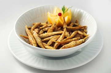 Smelt, capelin, small mackerel in corn batter with lemon