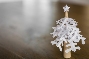 Paper snowflakes christmas tree on wood table