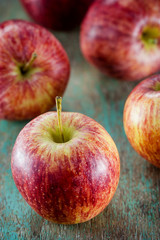Ripe red apples on wooden background
