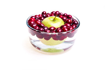 Cranberries and apple, small bowl, side view.
