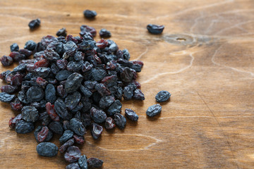 blue raisins on wooden background