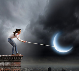 Woman catching moon