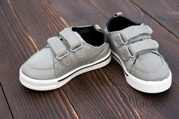 pair of grey shoes on wooden background