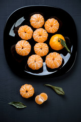 Close-up of a plate with mandarins, vertical shot, above view