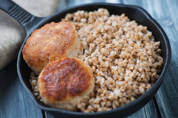 Close-up of buckwheat with roasted meat cutlets, studio shot