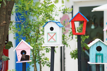 white wooden bird house in garden