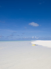 Fototapeta na wymiar Yellow flippers on the white Maldivian beach