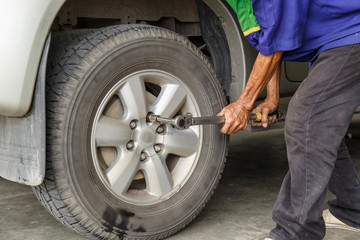 Man checking and filling the air on tire
