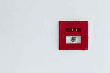 Old red box fire alarm  on cement wall