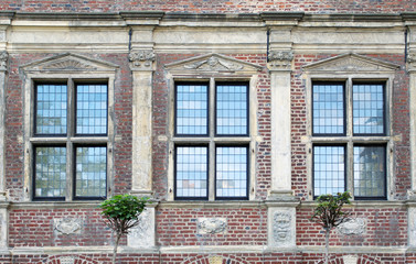 Three windows of old Raesfeld water castle in Germany