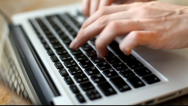 Woman's hands typing on computer keyboard (HD)