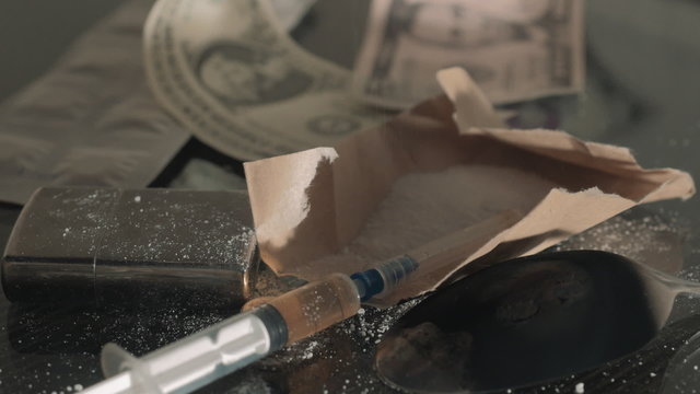 Drug syringe and cooked heroin on spoon HD