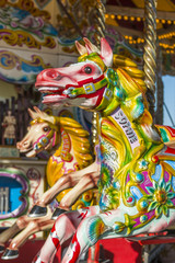 Fototapeta na wymiar Carousel horses on a fairground ride