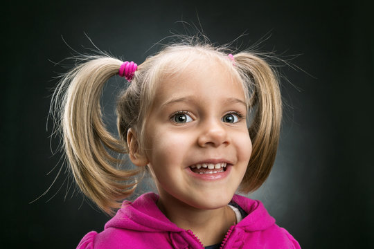 Little girl in rose jacket smiling