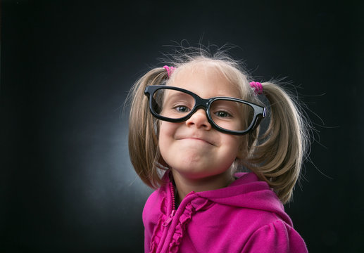 Little girl in funny big spectacles