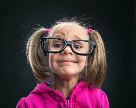 Funny little girl in funny big spectacles