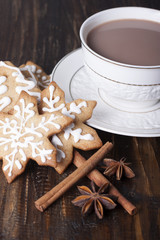 Christmas gingerbread cookies and cocoa in a white cup.