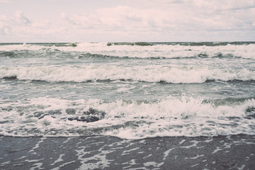 water waves rushing in sand. Vintage.
