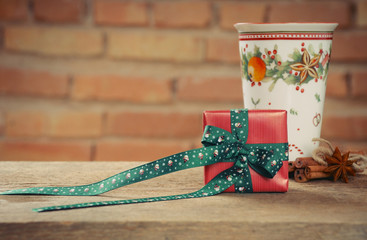 small cute present box and cup of tea with cinamon for Christmas
