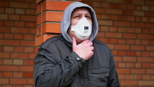 Man in the air mask at outdoors near building
