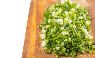 Spring onion or scallions on wooden cutting board 