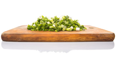 Spring onion or scallions on wooden cutting board 