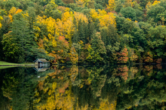 Boathouse Along Lake in Fall - Powered by Adobe