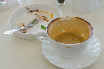 Empty coffee cup and empty dish