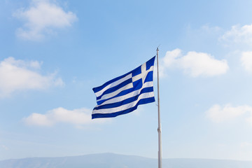 Greek flag with sky in Athens, Greece