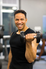 athletic man excising with dumbbells