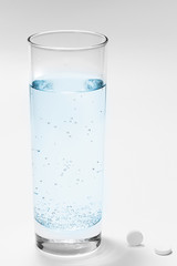 glass with water and pills